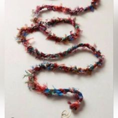 the necklace is decorated with multicolored beads