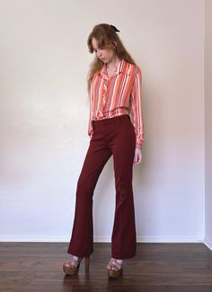 Vintage 1970s Lasso Flared Rodeo Pants, Western Style. Classic Western style with wide triangle pointed belt loops. The fabric is a dark maroon-brownish polyester These pants fit at a mid-rise and have a zipper fly with hook closure at the waist. The fabric does have some light give to it. **clipped to fit model.** CONDITION Good vintage condition. Some wear to the fabric and color fade lines on the lap.  MEASUREMENTS Size: M waist: 30 inch  hip: 37 inch  rise: 9.5 inch  inseam: 33 inch  **Items are measured laying flat. Chest, waist, and hip have been doubled already.** NO RETURNS for improper fit. Please read FAQ page for more information about our policies*EU & UK sellers only: Per distance selling laws, returns fees will be accepted within 14 days of the items delivery date.* The size Flare Pants, Workout Pants, Bell Bottoms, Rodeo, Trousers Women, Mid Rise, Western Fashion, 1970s, Fitness Models