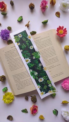 an open book surrounded by flowers and petals