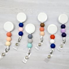 "This PERSONALIZED badge reel is just the thing you're looking for! It is made with a combination of silicone beads that have been permanently attached to this retractable badge reel. A variety of colors to choose from!! MAKE SURE TO INCLUDE A NOTE TO THE SELLER WITH YOUR BEAD COLOR AND ORDER. **ONLY INCLUDE THE NUMBER ASSOCIATED WITH THE BEAD AND NOT THE COLOR** EXAMPLES: (BEAD 1, 12, 20) (TOP BEAD 1, MIDDLE BEAD 12, BOTTOM BEAD 20) **These reels are personalized to order and therefore cannot b Adjustable Multicolor Retractable Badge Reel, Multicolor Retractable Badge Reel For Gift, Adjustable Retractable Multicolor Badge Reel, Multicolor Retractable Badge Reel, Bead Badge Reel, Mini Sharpie, Beaded Badge Reel, Owl Sewing, Personalised Badges