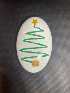 a painted rock with a christmas tree on it