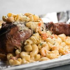 steak, macaroni and cheese on a plate