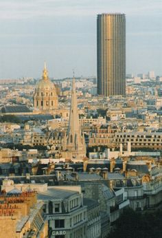 an aerial view of a city with tall buildings and a clock tower in the distance