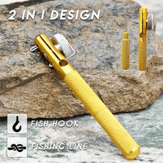 two in 1 design fish hook and fishing line on top of a rock next to a pair of scissors