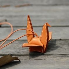 an origami bird made out of leather