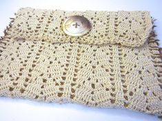 a crocheted purse with a button on it