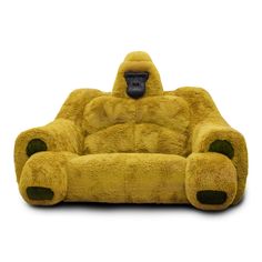 a large yellow chair with a gorilla face on it's back and legs, sitting in front of a white background