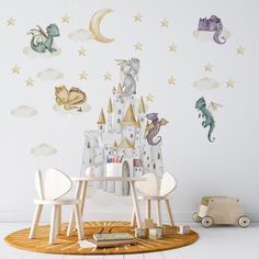 a child's room with a castle wall decal and toys on the floor