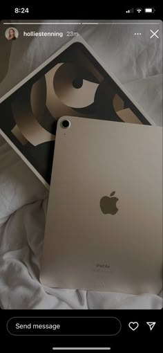 two ipads sitting next to each other on a bed