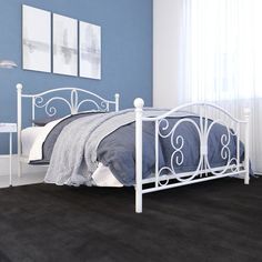 a white metal bed frame in a bedroom with blue walls and carpeted flooring