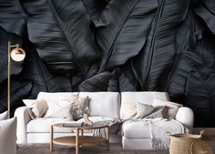 the living room is decorated in black and white with large, leafy wallpaper