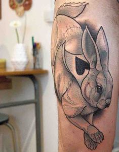 a black and white tattoo of a dog on the leg