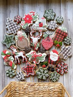 decorated christmas cookies in a wicker basket next to a basket filled with other holiday treats