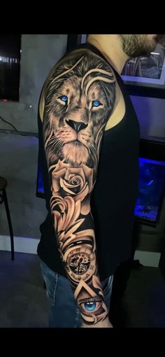 a man's arm with a lion and roses tattoo on the left side of his arm