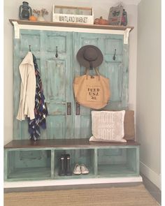 a coat rack with shoes and bags on it next to a wall mounted coat rack