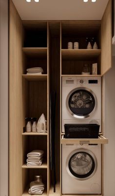 a washer and dryer are in the closet next to each other with shelves