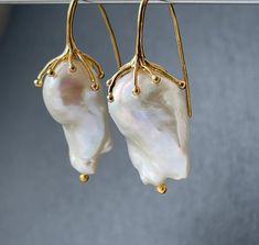 Large freshwater iridescent white baroque pearl drop earrings for women in 18k gold plated on 925 sterling silver that would make a real statement on your wedding day! With amazingly beautiful lustre and aaa grade, these elegant earrings would make exquisite jewelry gifts for a bride or mother of the bride or groom These high quality cultured pearls come naturally in different shapes but these pairs have been bought specially as a closely matched pair. The natural variations in shape adds to the Delicate Baroque Pearl White Earrings, Handmade Baroque Pearl Drop Earrings, Handmade Delicate Baroque Pearl Earrings, Delicate Handmade Baroque Pearl Earrings, Handmade Baroque Pearl Jewelry For Formal Occasions, Handmade Formal Baroque Pearl Jewelry, Single Drop Baroque Pearl Earring, Yellow Gold Baroque Pearl Earrings Gift, Baroque Pearl Teardrop Earrings For Gift