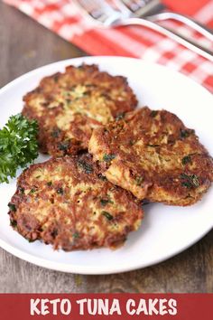 some food is on a white plate with a fork and knife next to it that says paleo tuna cakes