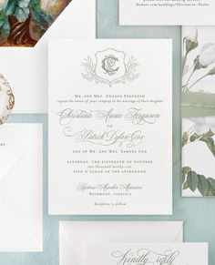 the wedding stationery is laid out on top of each other, including envelopes and cards