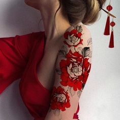 a woman with red flowers on her arm