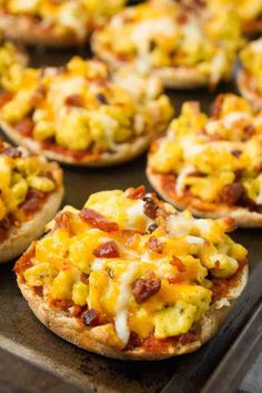 mini pizzas with cheese and bacon on them are ready to be eaten in the oven