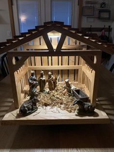 a nativity scene is displayed on a wooden table