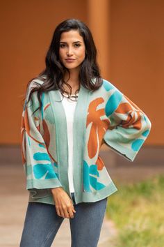 This beautiful jacquard knit cardigan from Adbel Ataurima in Peru is just the thing when you need a lightweight extra layer. The soft jacket-style sweater is knit from a comfortable cotton and viscose blend in complementary shades of orange turquoise celadon cream and silver. Fall Jacquard Knit Cardigan For Layering, Multicolor Jacquard Knit Cardigan For Spring, Spring Multicolor Jacquard Knit Cardigan, Casual Jacquard Knit Outerwear For Spring, One Size Sweater Coat For Spring Layering, Green Jacquard Knit Outerwear For Fall, Spring Green Soft Knit Sweater Coat, Jacquard Knit Outerwear For Layering, Jacquard Knit Cardigan For Layering