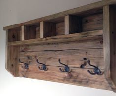 a wooden shelf with hooks on it