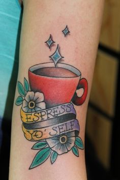 a tattoo on the arm of a woman with a cup of coffee and ribbon around it