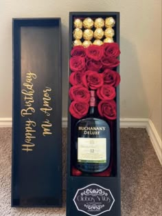 a bottle of booze and roses in a black box with a happy birthday message