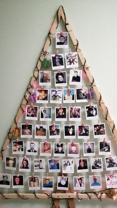 a christmas tree made out of photos and clothes pins is displayed on a white wall