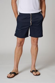 • Designed + Manufactured in Los Angeles • Stretch Woven Twill • 6.5" Inseam •Technical premium fabric imported from Japan • Elastic Waistband with Drawstring • Back Pocket with Zipper • Signature square Leisure Lab pockets • 100% Polyester Cotton Swim Trunks Short Length, Navy Short Length Swim Trunks, Navy Shorts With Elastic Waistband For Spring, Navy Bermuda Shorts For Summer, Navy Cotton Athletic Shorts, Navy Cotton Shorts For The Beach, Navy Cotton Shorts For Vacation, Navy Cotton Beach Shorts, Navy Cotton Vacation Shorts