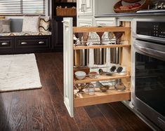 an open cabinet in the middle of a kitchen