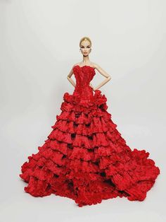 a mannequin dressed in a red dress with ruffles on the skirt