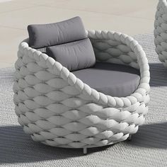 two white wicker chairs sitting on top of a carpeted floor next to each other