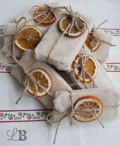 orange slices are wrapped in burlap and tied with twine on top of each other