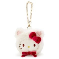 a hello kitty keychain with a red bow on it's head and ears