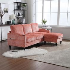 a living room with an orange couch and white rug