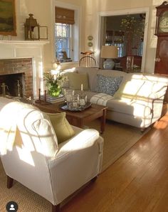 a living room filled with furniture and a fire place under a clock mounted on the wall