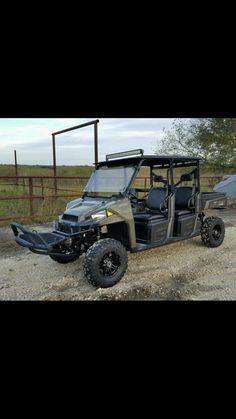 an off - road vehicle parked on the side of a dirt road