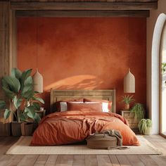 a bedroom with an orange wall and wooden flooring that has plants on the side