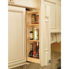 an open cabinet in the middle of a kitchen with spices and condiments inside