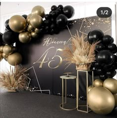 black, gold and white balloons are on display