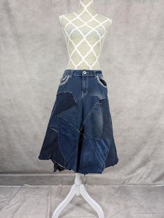 Upcycled denim patchwork skirt with frayed seams for a distressed look. Decorative metal studs on pockets. Waist measures 32" and length is approximately 29". Recycled Denim Patchwork Denim Skirt, Patchwork Denim Skirt In Recycled Denim Blue, Denim Blue Patchwork Skirt From Recycled Denim, Recycled Denim Patchwork Skirt, Denim Blue Patchwork Denim Skirt, Dark Wash Patchwork Denim Skirt, Recycled Denim Blue Skirt With Patchwork, Distressed Cotton Denim Skirt, Medium Wash Denim Skirt With Patchwork