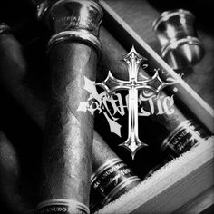 an image of a cross with the word tattoo on it and some other items in a box