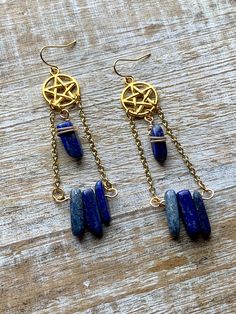 Handmade with gold tone chain and charms, and lazurite stones. Measures about 3.25 inches tall Symbolic Blue Metal Jewelry, Blue Brass Jewelry With Adjustable Chain, Celestial Metal Jewelry With Dangling Charms, Blue Brass Dangle Jewelry, Mystical Brass Dangle Jewelry, Blue Spiritual Dangle Earrings, Symbolic Brass Dangle Jewelry, Spiritual Blue Dangle Earrings, Mystical Wire Wrapped Dangle Jewelry