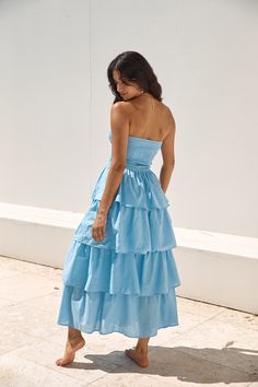 Feel like a modern-day princess in the Glass Slipper Strapless Maxi Dress in Blue. Perfect for whimsical evening soirees as the sunsets. Style silver heels and adornments to radiate elegant energy. Maxi dress. true to size Strapless Stretch ruched bust to waist Tiered skirt Style slips on Semi-lined 100% Cotton. Lining: Rayon Non-stretch material Please refer to the care label on garment for specific instructions on how to care for it Model wears XS Length from bust to hem: 121cm on an S Chest 31cm. Waist 29cm. size S Blue Strapless Midi Dress For Prom, Blue Bandeau Strapless Dress For Evening, Chic Light Blue Strapless Dress, Chic Blue Strapless Dress For Prom, Summer Strapless Bandeau Prom Dress, Spring Evening Light Blue Strapless Dress, Summer Prom Strapless Bandeau Dress, Summer Strapless Ruffled Bridesmaid Dress, Light Blue Strapless Evening Dress For Spring