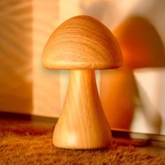 a wooden mushroom sitting on top of a carpet next to a lamp and window sill