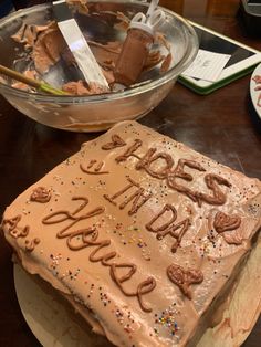 a birthday cake sitting on top of a table next to a bowl of chocolate chips