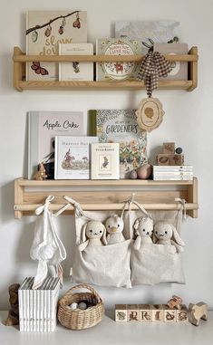 two wooden shelves with stuffed animals and books on them, along with other decorative items